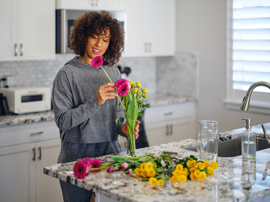 Woman Arranging Flowers at Home